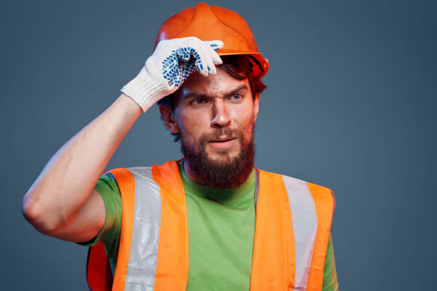 istock A man in orange paint. Hard work of a builder 1961949591
