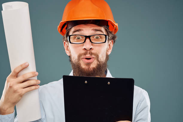 istock Man in glasses with documents orange helmet safety work construction 1961953240