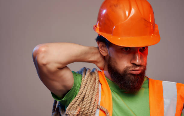 istock Male builder in orange hard hat work fatigue industry 1961955927