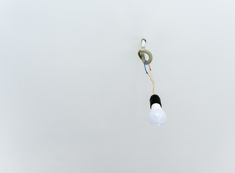 LED light bulb in a holder on a white ceiling