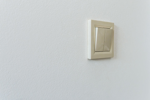 Electric switch on a white wall