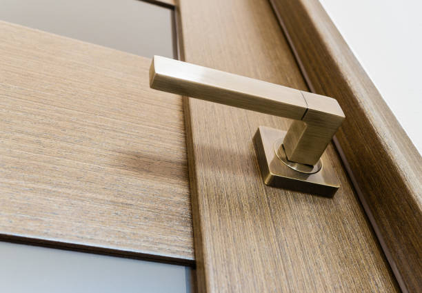 istock Door handle on a wooden interior door with glass inserts 1961959171