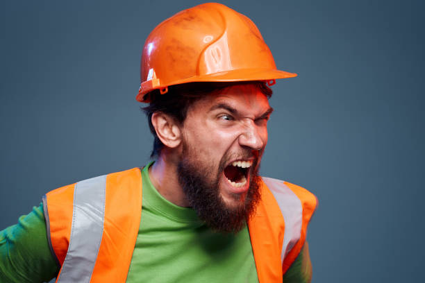 istock Emotional builders orange hard hat safety work fatigue blue background 1961960232