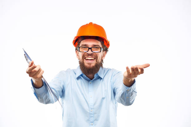 istock Cheerful man in orange hard hat construction documents service professionals 1961960249