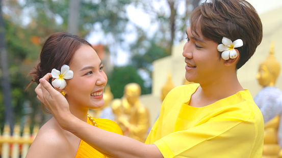 Young couple wears traditional Thai clothing during the Songkran festival.