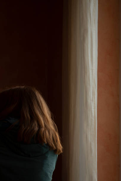 istock a woman by the window 1961982486