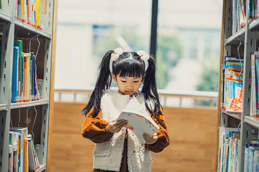 A girl reading books in the library