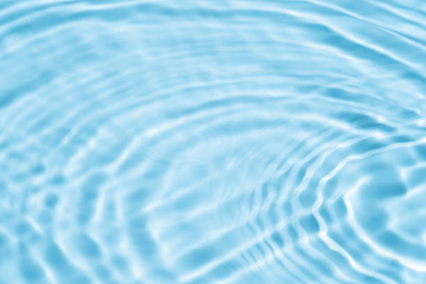 istock Background summer natural blue texture, clear water with ripples and splashes. Water waves in sunlight with leaf shadow, and background concept of cosmetics, moisturizer, and toner 1961998125