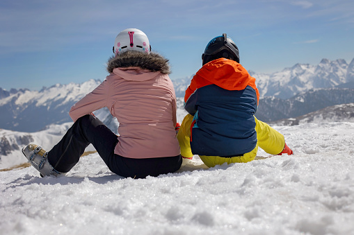 Happy family, enjoying ski holiday with children, sunny beautiful weather outdoors