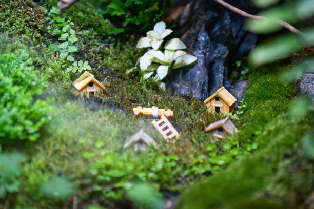 istock Wooden miniature house model on a moss in forest. 1962004444