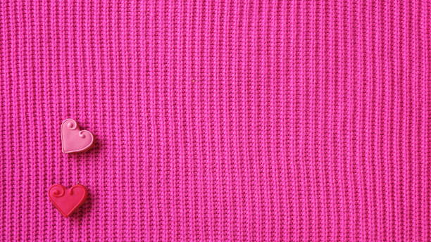 istock Two gingerbread hearts on a knitted pink background 1962019668