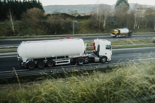 A truck with a bulk commodity trailer on a highway