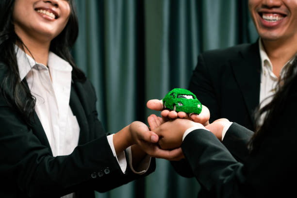 istock Business people synergy holding EV car model. Quaint 1962053561