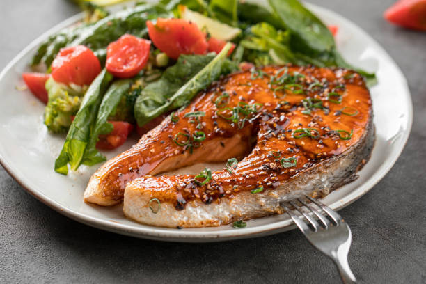 istock Portion of grilled salmon steak with vegetables 1962058596
