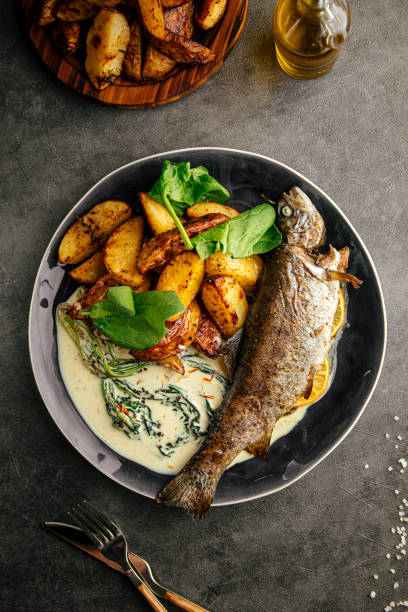 istock Portion of grilled fish with potato and sauce 1962058602