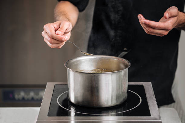 istock Chef boiling water in a steel pot 1962058615