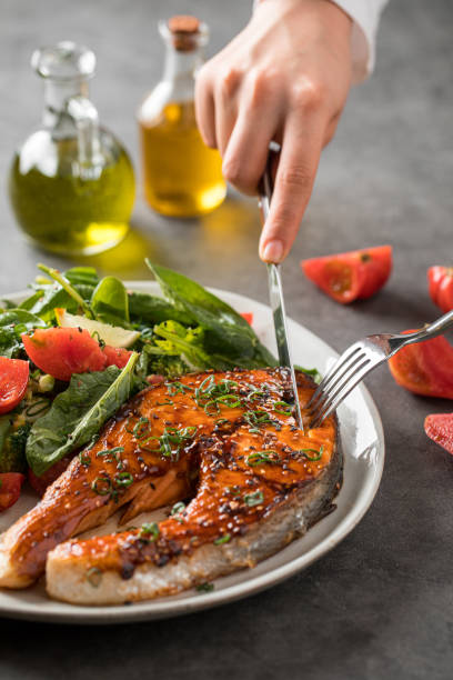 istock Eating grilled salmon steak with vegetables 1962058647