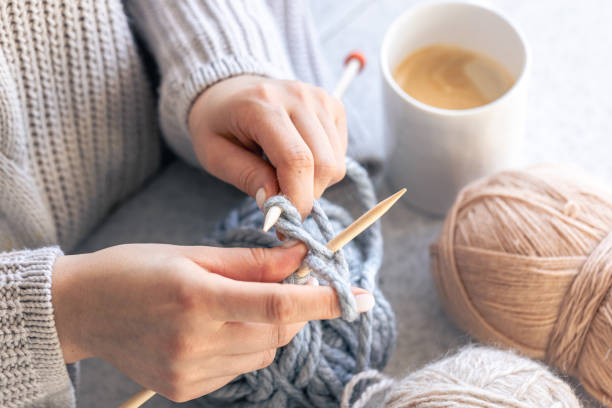 istock A woman knits with gray thread, close-up. 1962061874