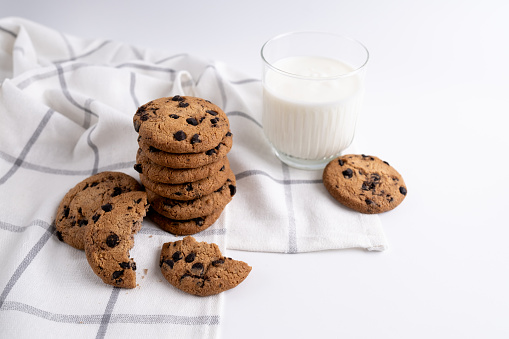 Stack of delicious cookies with chocolate and milk or yogurt on the table. Food and sweet concept. Place for text. Sweet snack