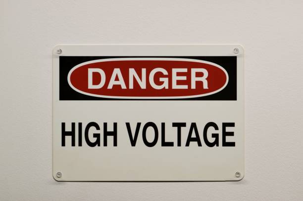 istock Danger High Voltage plastic warning sign isolated and attached to a white wall with push pins. 1962104405