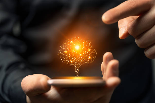 istock Artificial intelligence tree symbol on smartphone in the hands of a man 1962140458