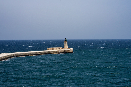 Light tower in Valetta surrounded by the blue sea