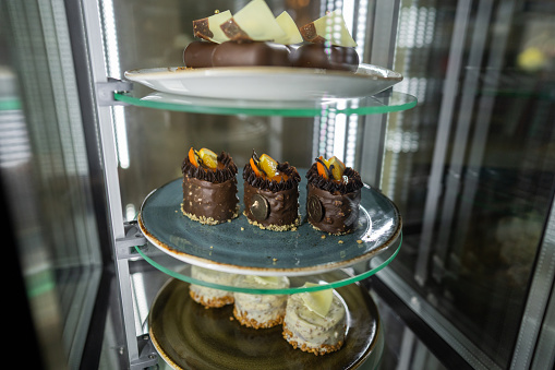 Close-up shot of cakes in glass cabinet without people