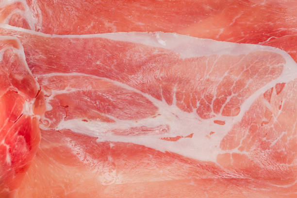 Top view of the thin slices of jamon laid out on a dish, background, texture