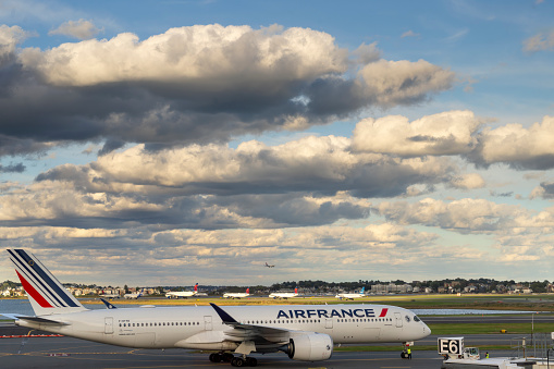 Logan International Airport, Boston Massachusetts, USA - October 2023.  Aircraft on the hard standing and the runway at the airport.