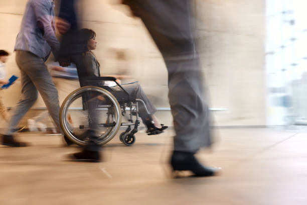 istock Assisting disabled colleague in blurred motion! 1962200135