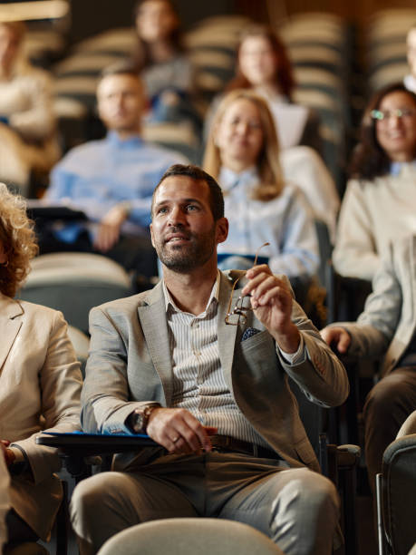 istock Businessman talking on an education event in convention center. 1962201713