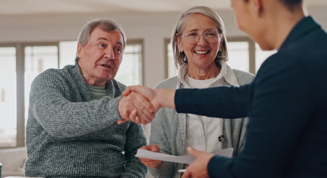 Old couple, financial advisor and handshake for insurance, retirement or deal for savings plan. Senior man, woman and consultant in meeting, agreement and paperwork, contract or documents for pension