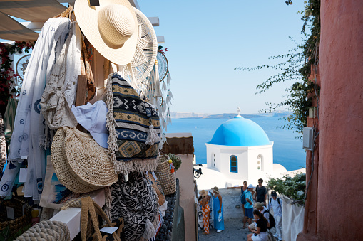 Street with shops and souvenirs for tourists in Oia, Santorini Island. Santorini is a volcanic island in the Aegean Sea and a famous summer resort.