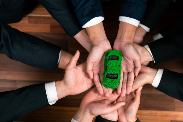 istock Business people synergy holding EV car model. Quaint 1962242429