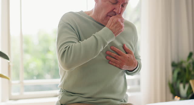 Coughing, senior man and chest or sick, breathing and lung illness or asthma. Elderly person, massage for relief and suffering from pulmonary issue or tuberculosis, healthcare and medical emergency