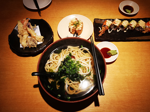 Focus scene on Japanese food - Tempura Udon and sushi in restaurant
