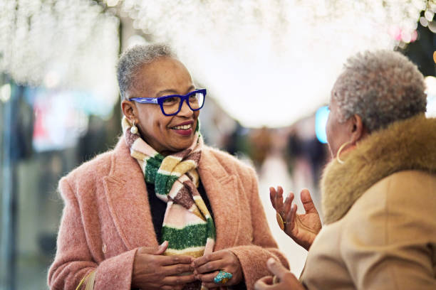 istock Cheerful women pausing to talk while window shopping 1962248162