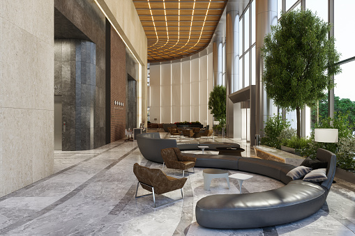 Luxury Hotel Waiting Lounge With Sofa, Armchairs, Elevators And Potted Plants