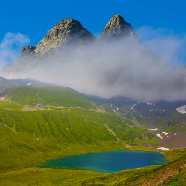 istock small lake in bautiful green mountain valley in dense mist and clouds 1962281400