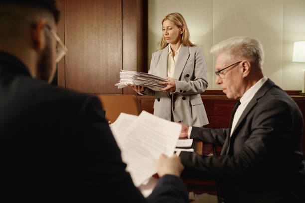 istock Female Attorney and Her Male Colleagues Working with Documents 1962300323