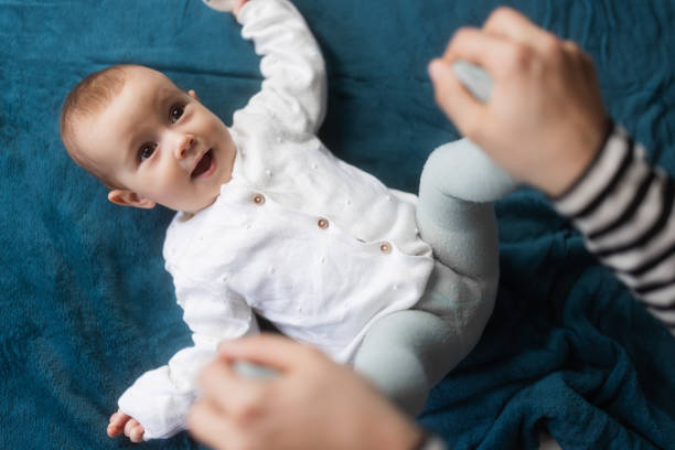 istock Cute baby playing with unrecognisable mother 1962302411
