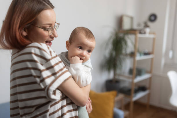 istock Beautiful mom interacting with her infant at home 1962302928