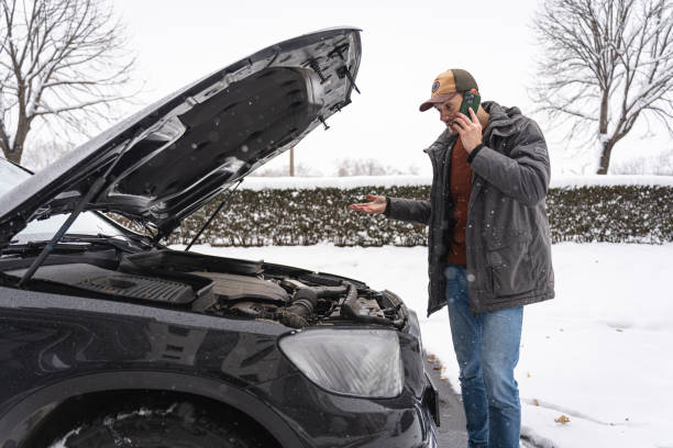 istock Worried driver talking on mobile phone, while standing near car, after an vehicle breakdown in winter cold weather 1962331621