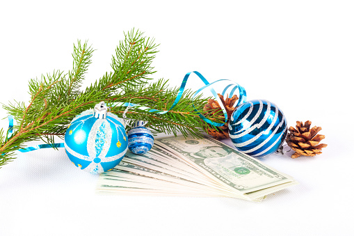 Fir branch, Christmas tree decorations, pine cones, dollar bills and streamers on a white background. Ideal for New Year card or invitation design.