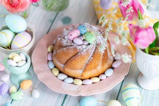 istock Easter yeast cake sprinkled with powdered sugar, decorated with chocolate eggs. 1962343912