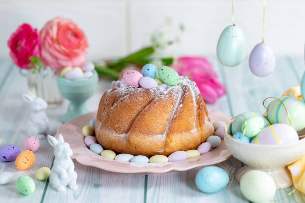 istock Easter yeast cake sprinkled with powdered sugar, decorated with chocolate eggs. 1962343970