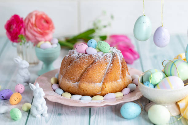 Easter yeast cake sprinkled with powdered sugar, decorated with chocolate eggs. stock photo