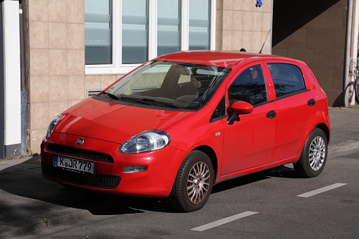 Fiat Grande Punto hatchback city car parked in Germany. There were 45.8 million cars registered in Germany (as of 2017).