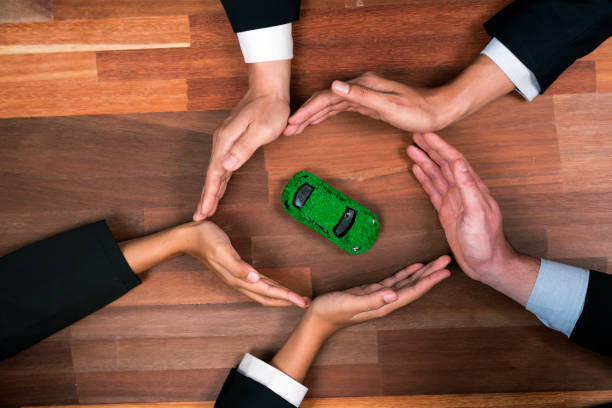istock Business people synergy holding EV car model. Quaint 1962354082