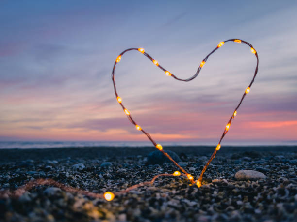 istock heart symbol with bright fairy lights 1962384430